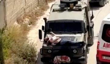 Cisjordanie: des soldats israéliens attachent un Palestinien sur un véhicule militaire